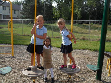 Children riding trio swings